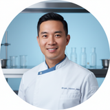 Circular portrait of a smiling man, Ryan Park, a person of color with short dark hair, looking directly at the camera. The ba