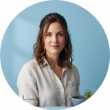 Mia Thompson, a woman with dark hair, smiles at the camera in a circular portrait against a soft blue background.
